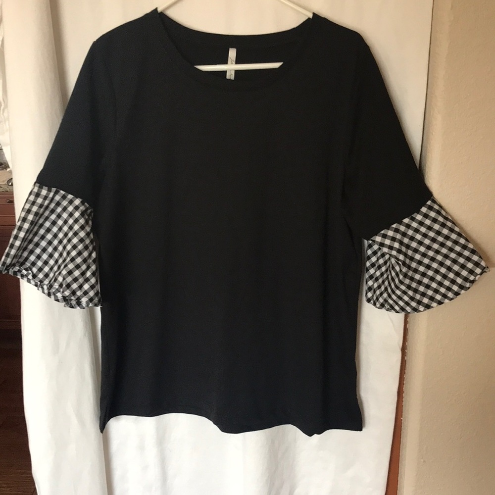 Solid black top with Black and whitecheckered flare sleeves